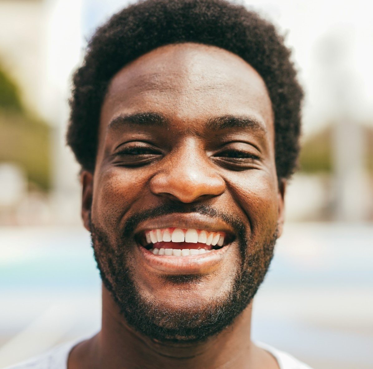 happy african man smiling at camera inside ba 1.jpg